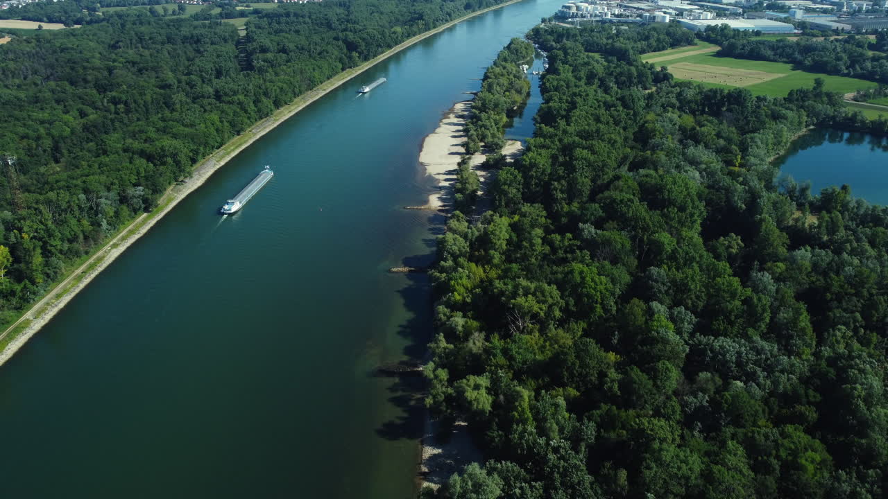 Aerial view of a river with a boat and lush green banks