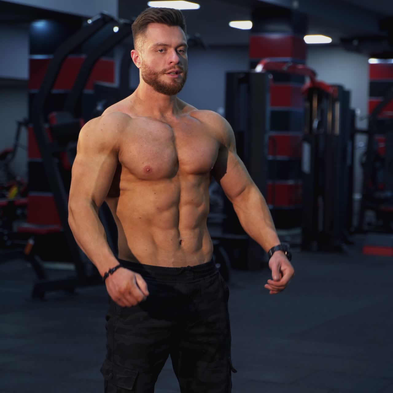 Handsome muscular man doing exercise with a heavy barbell. Athletic shirtless man training, Sportsman doing strength and endurance exercises with barbell. Workout in the gym