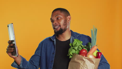 cheerful guy recommends bio homegrown goods on video call