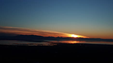 Gorgeous-aerial-drone-view-of-Utah-lake-during-a-golden-sunset-on-a-warm-fall-evening-in-Provo