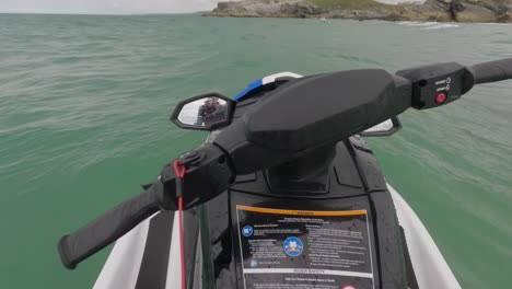 pov shot of a jet ski rider floating with a tandem taking off at newquay