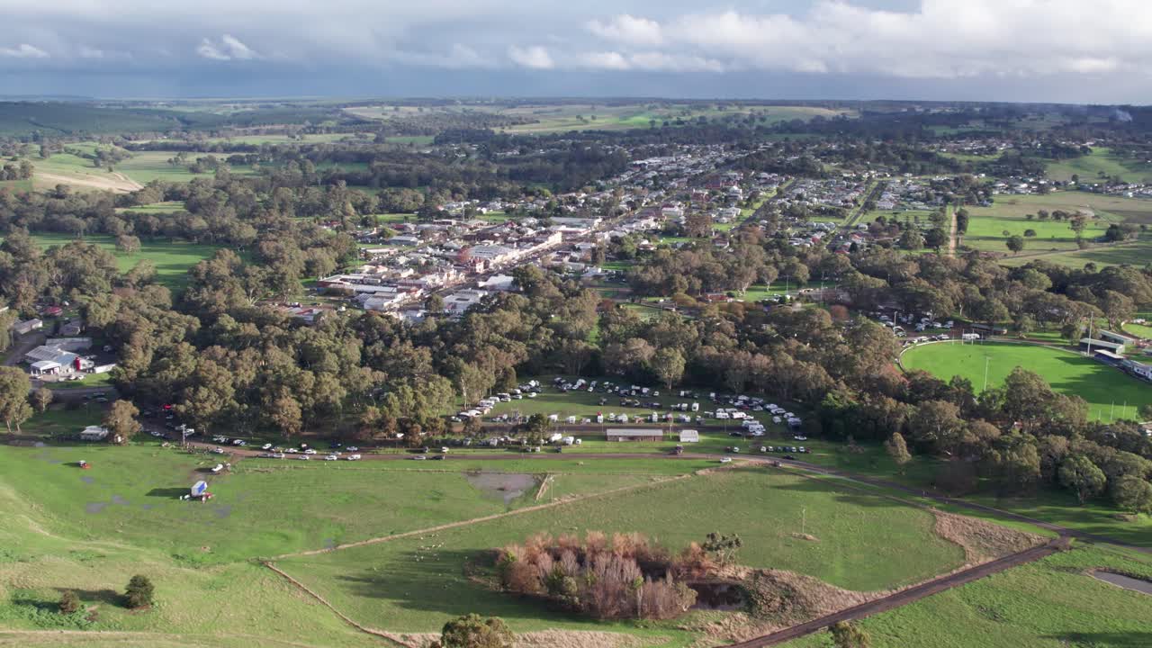 Rising aerial view over the town of Casterton and surrounding landscape in western Victoria, Australia. June 2023.