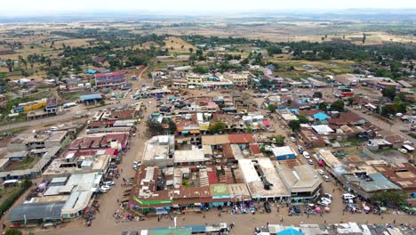 aerial view of cars and people at a open air market, in africa - reverse, drone shot