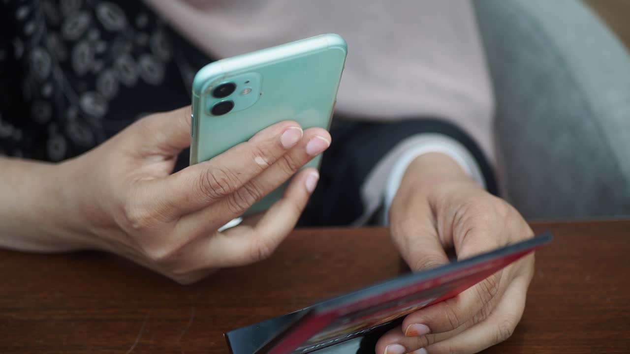 Hands holding a phone and card