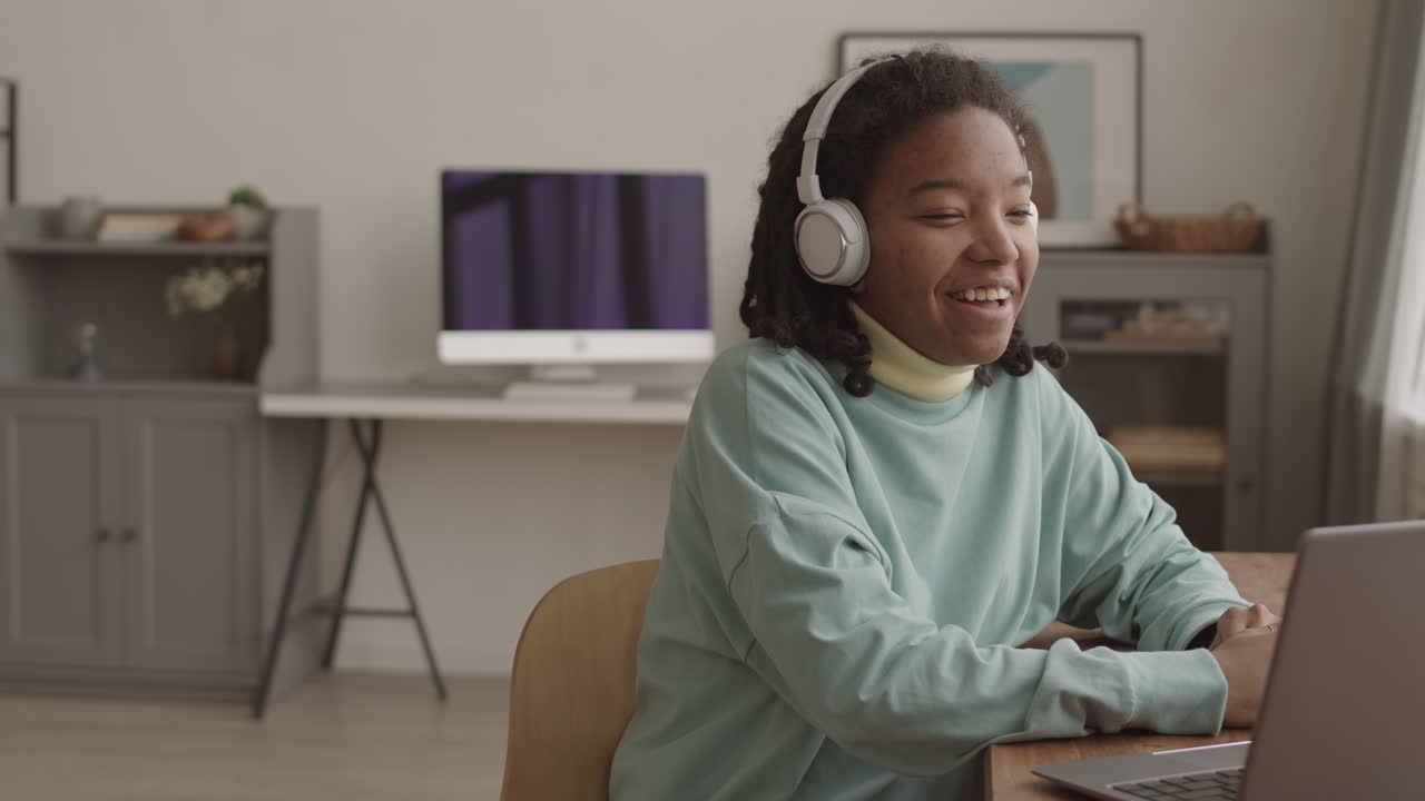 Joyful African Girl Having Video Talk with Friend