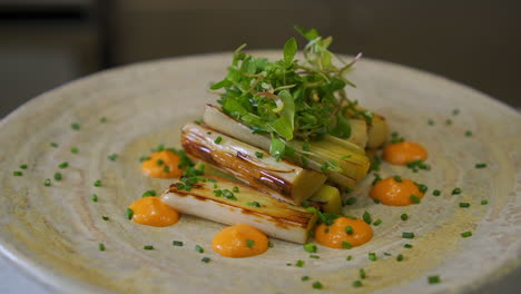 grilled leeks with sauce and sprouts