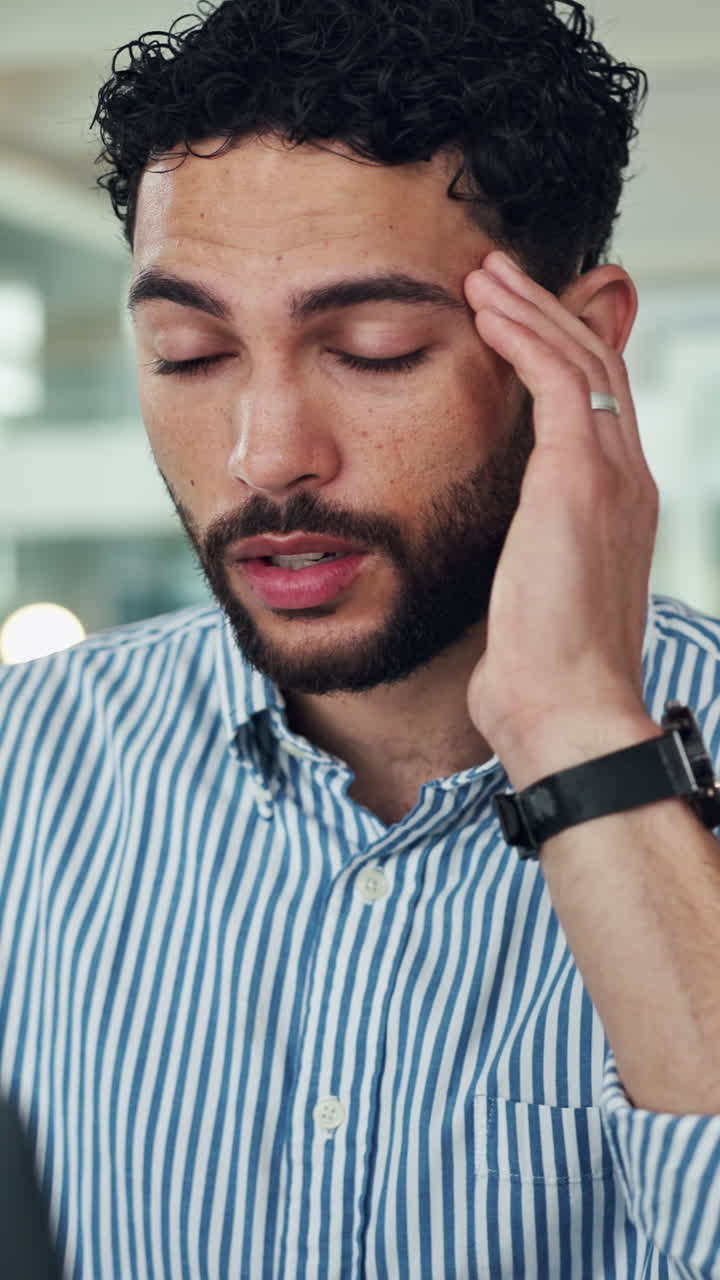 Stressed Man Rubbing Temples Suffering from Headache in Office