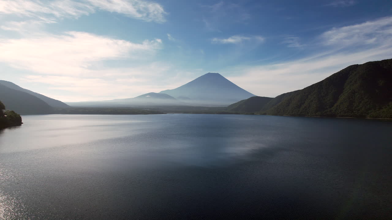 Aerial delight A drone's graceful pullback reveals Lake Motosu with the iconic Mount Fuji majestically dominating the background