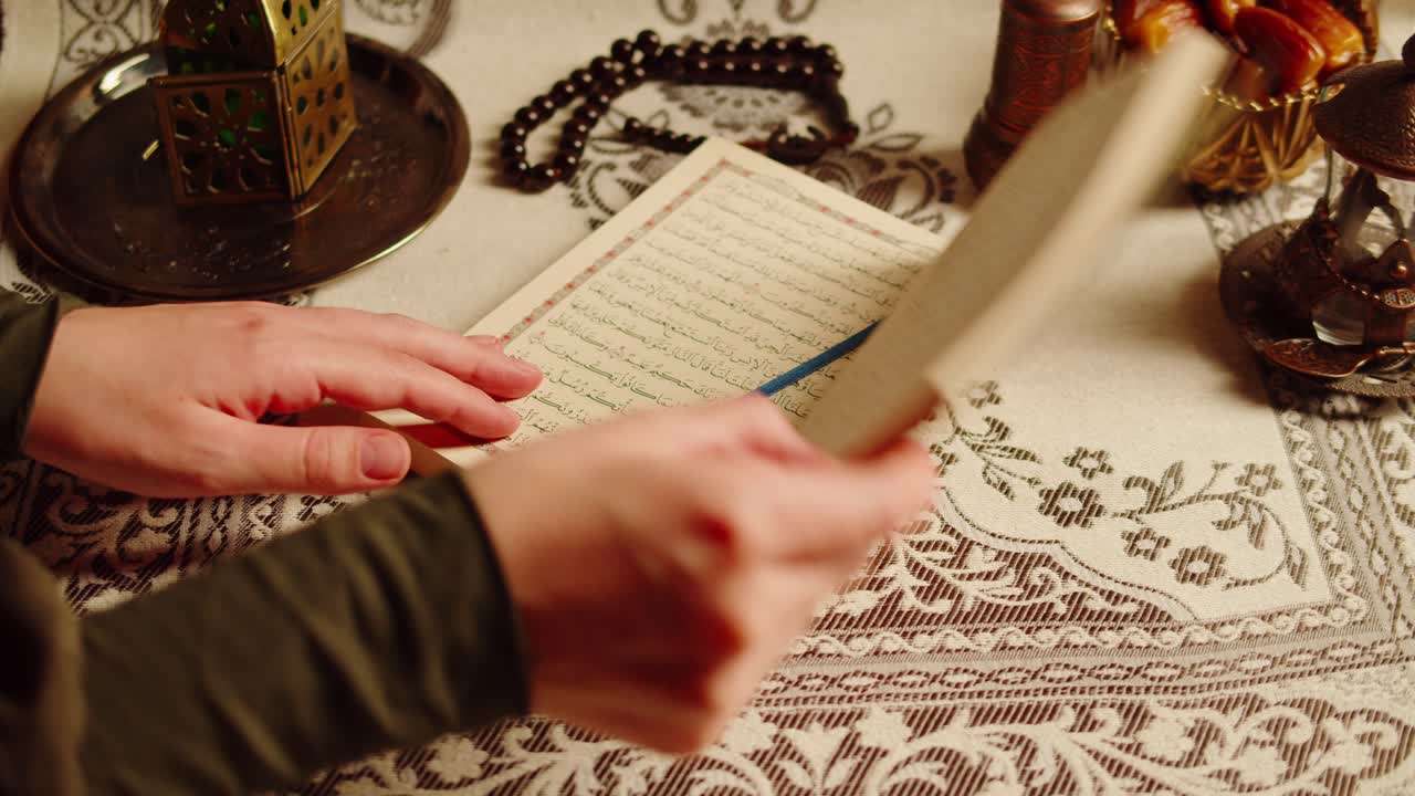 Quran book close-up, praying, islamic religion. Religious holiday Ramadan, holy month. Worship, making traditional prayer to God