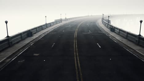 long bridge in misty fog