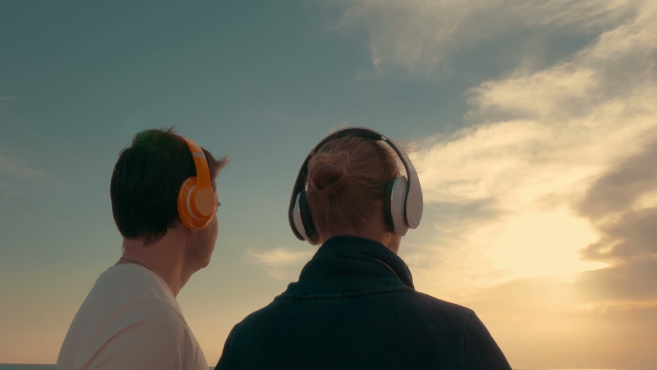 él y ella admirando el sol de la tarde sobre el mar