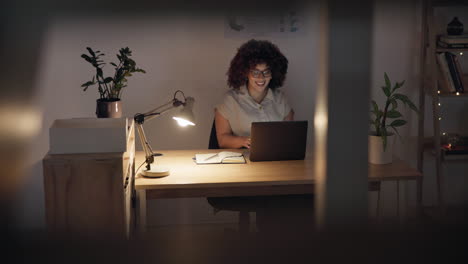 smile, night and woman with a laptop in an office