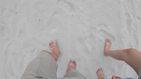 Engaging-point-of-view-footage-featuring-a-person's-legs-walking-on-sandy-terrain