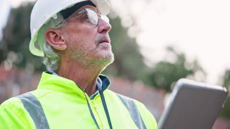 construction worker using a tablet on site