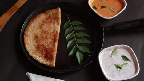 rotating masala dosa is a south indian meal served with sambhar and coconut chutney