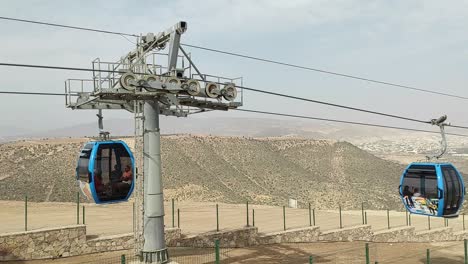 cable car of the aerial tramway connecting oufella peak and agadir city in morocco, overlooking a panoramic view of the beach-14