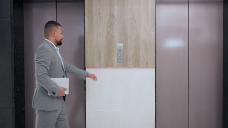 man waiting for elevator
