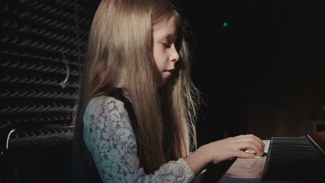 charming girl operates digital piano