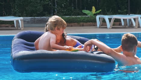niños sonrientes y felices en un flotador en una piscina.