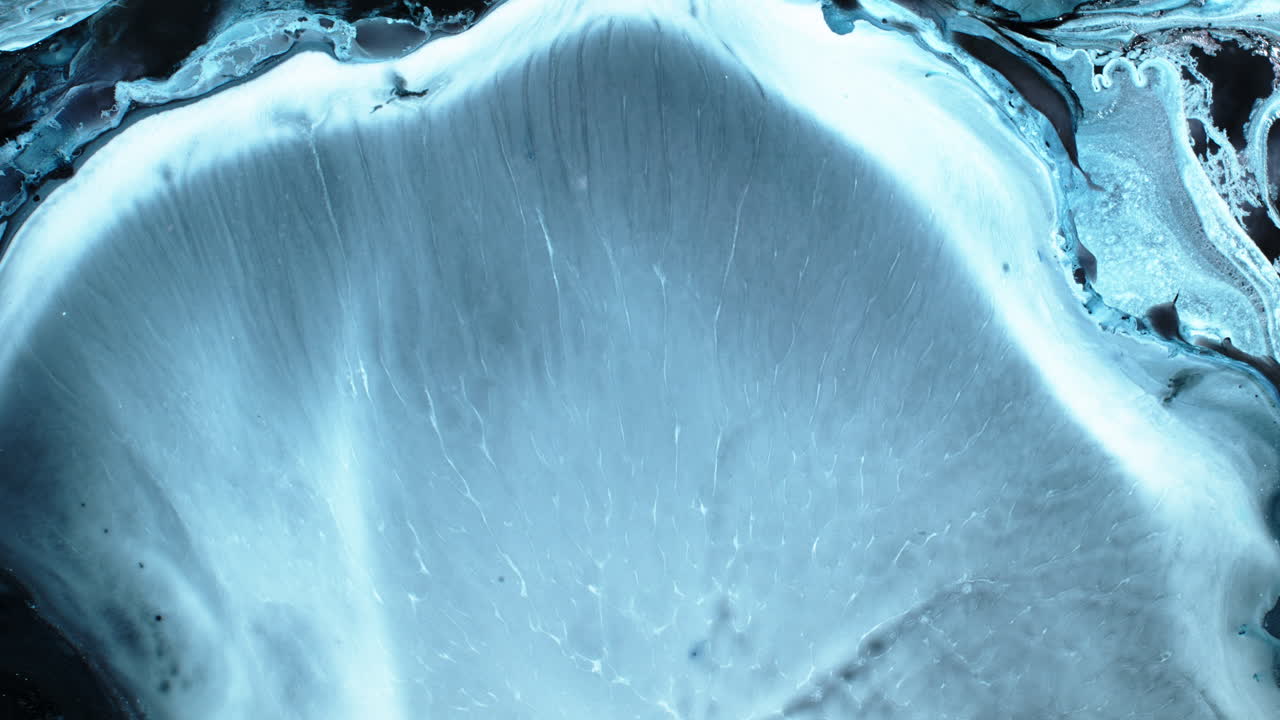 Close-up of mixing substances in motion, creating a fluid art effect