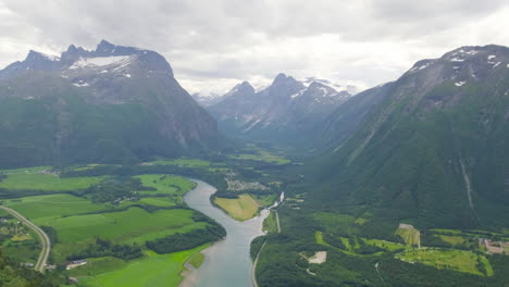 beautiful scenery of rauma river through the mountains of romsdalen in andalsnes, norway with romsdal fjord revealed