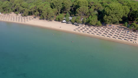 Aerial:-Panoramic-view-over-koukounaries-beach-at-southern-Skiathos-island,-Greece-on-a-sunny-day