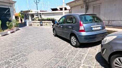 boy cycling near parked cars in sorrento