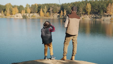 father and son fishing in autumn