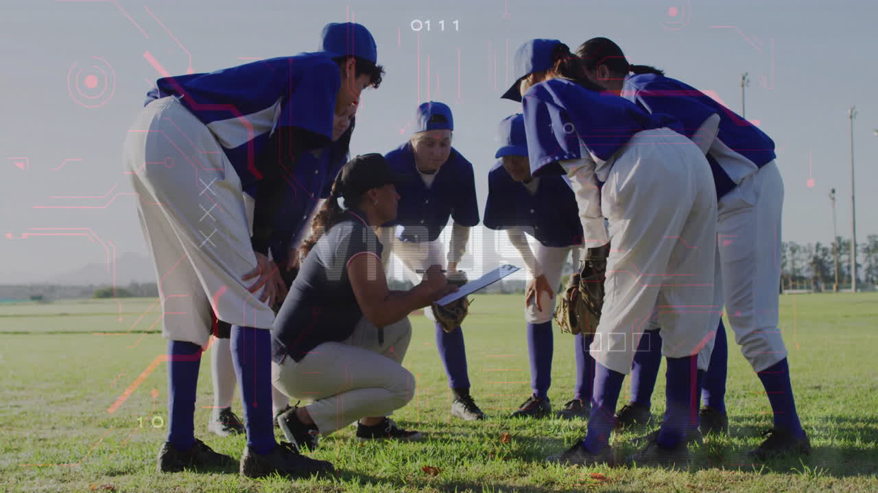 In blue uniforms, baseball team huddling around coach with clipboard on field