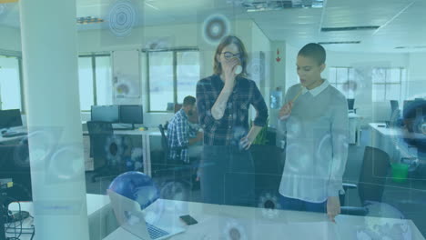 Two colleagues discussing work over digital interface animation in modern office