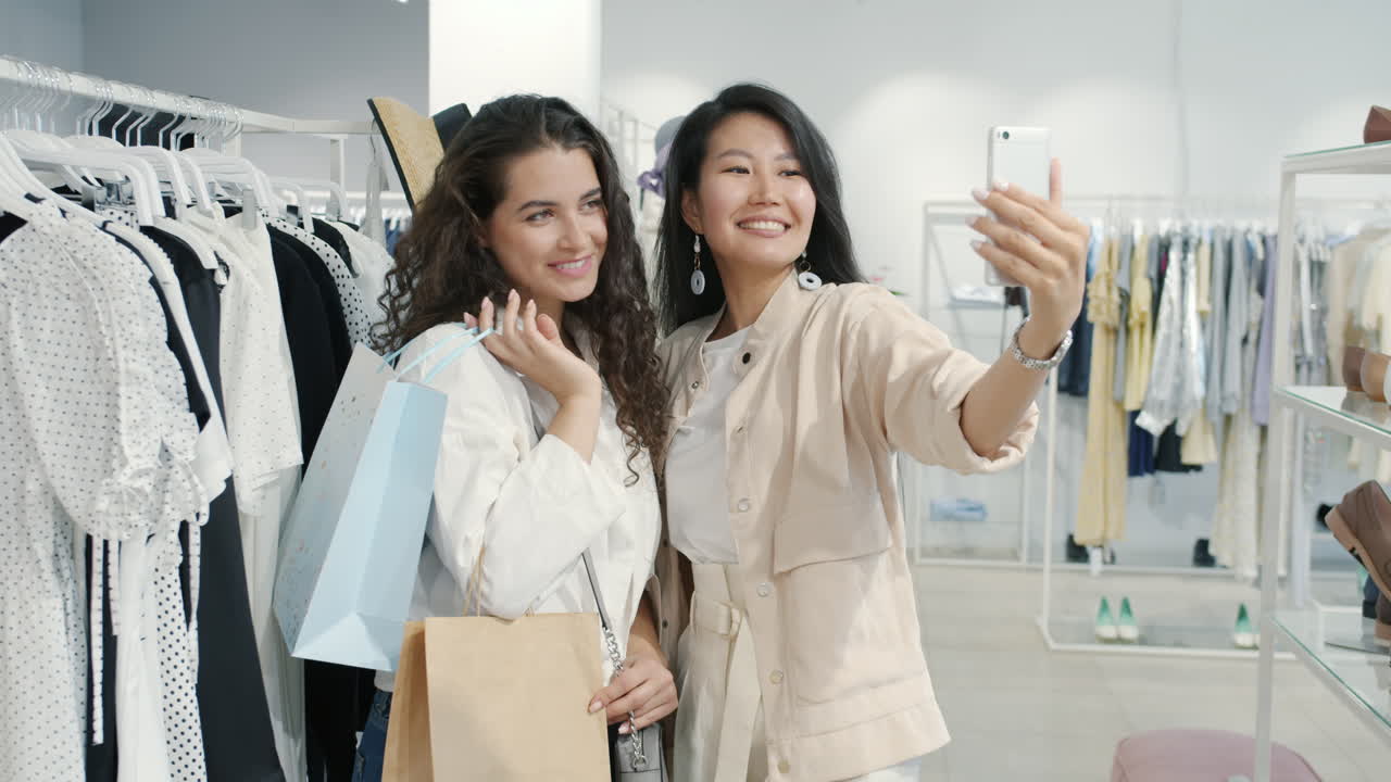 Two women taking a selfie in a clothing store