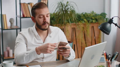 rich businessman in shirt working on laptop pc counting money cash calculate earnings income profit