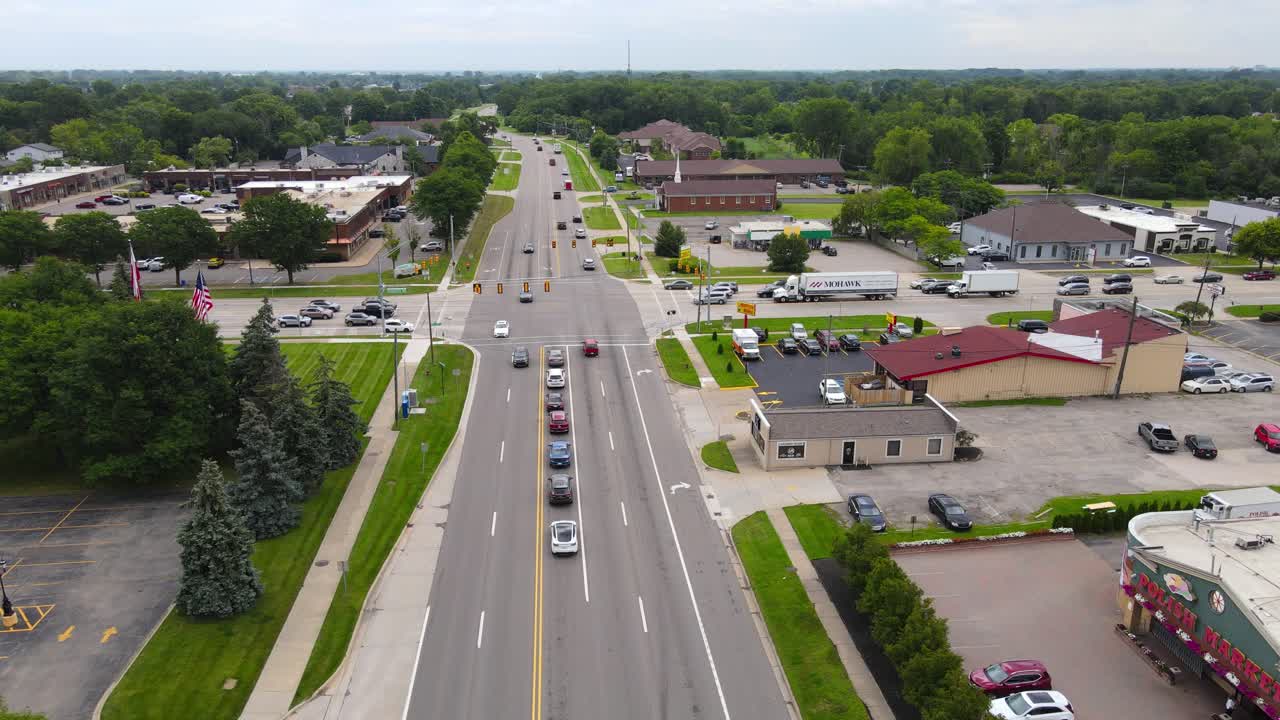 Storm clouds flow over small township of Troy in Michigan, aerial view