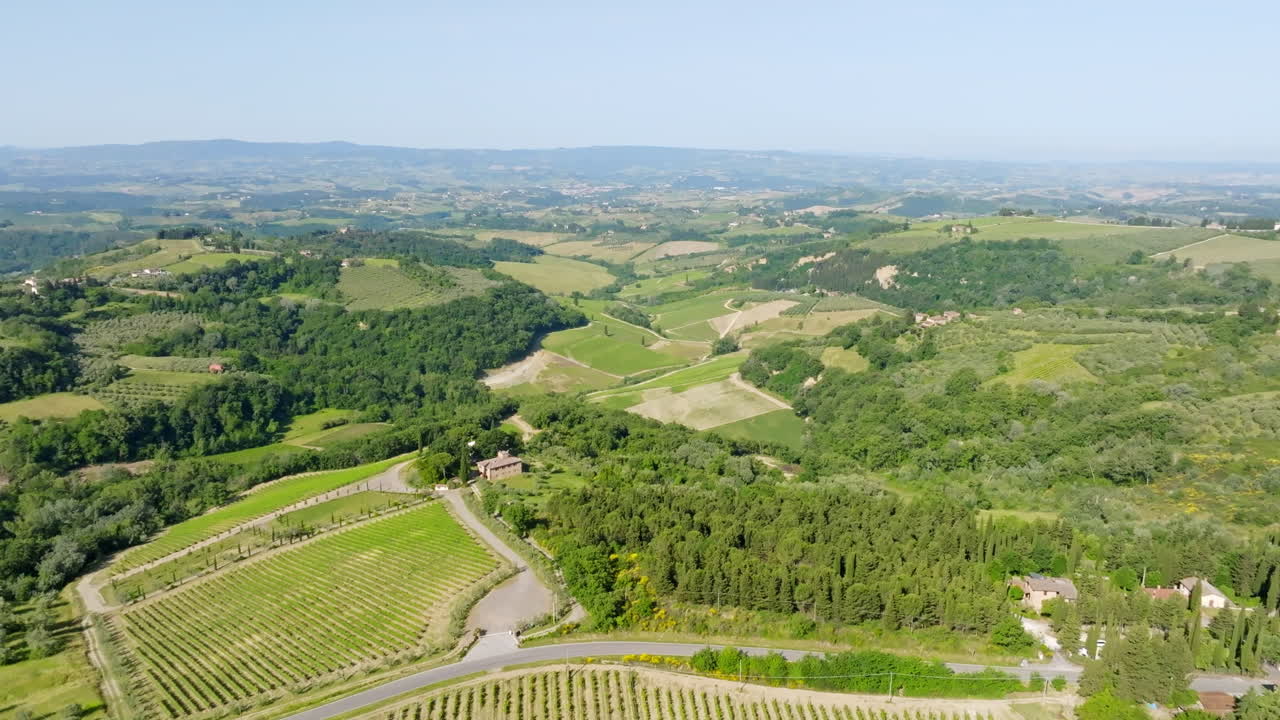 Aerial view backwards over vineyards and nature of the Tuscan countyside in Italy