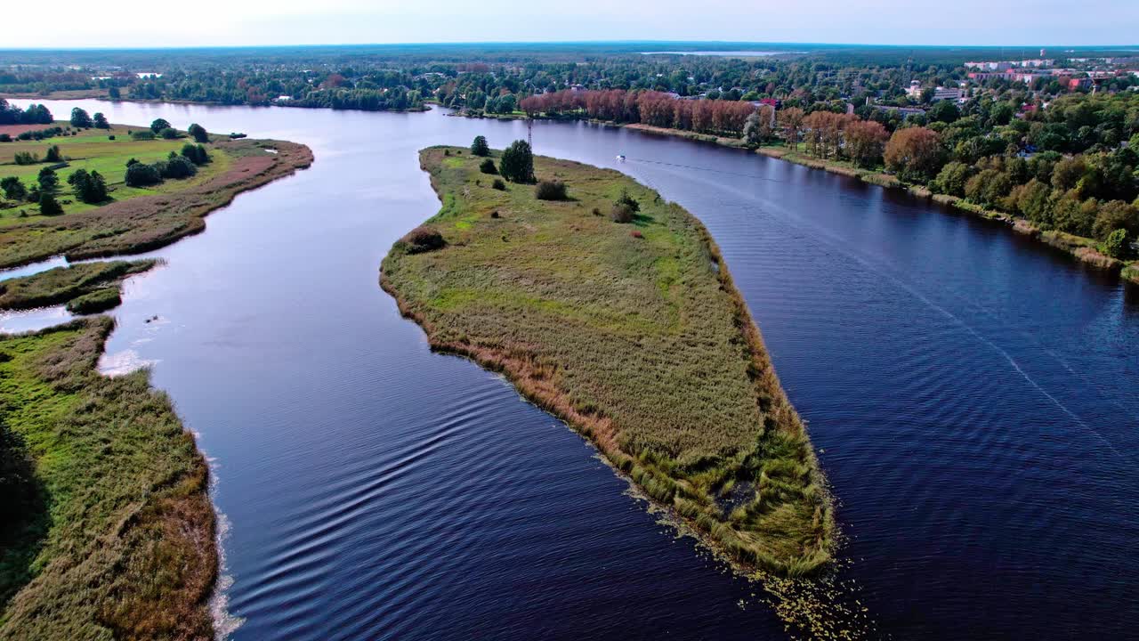 Scenic aerial view of river and landscape in Latvia during sunny weather