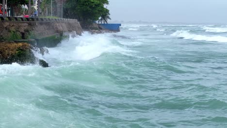 aerial flyover caribbean sea with crashing waves against coastline while hurricane season in dominican republic