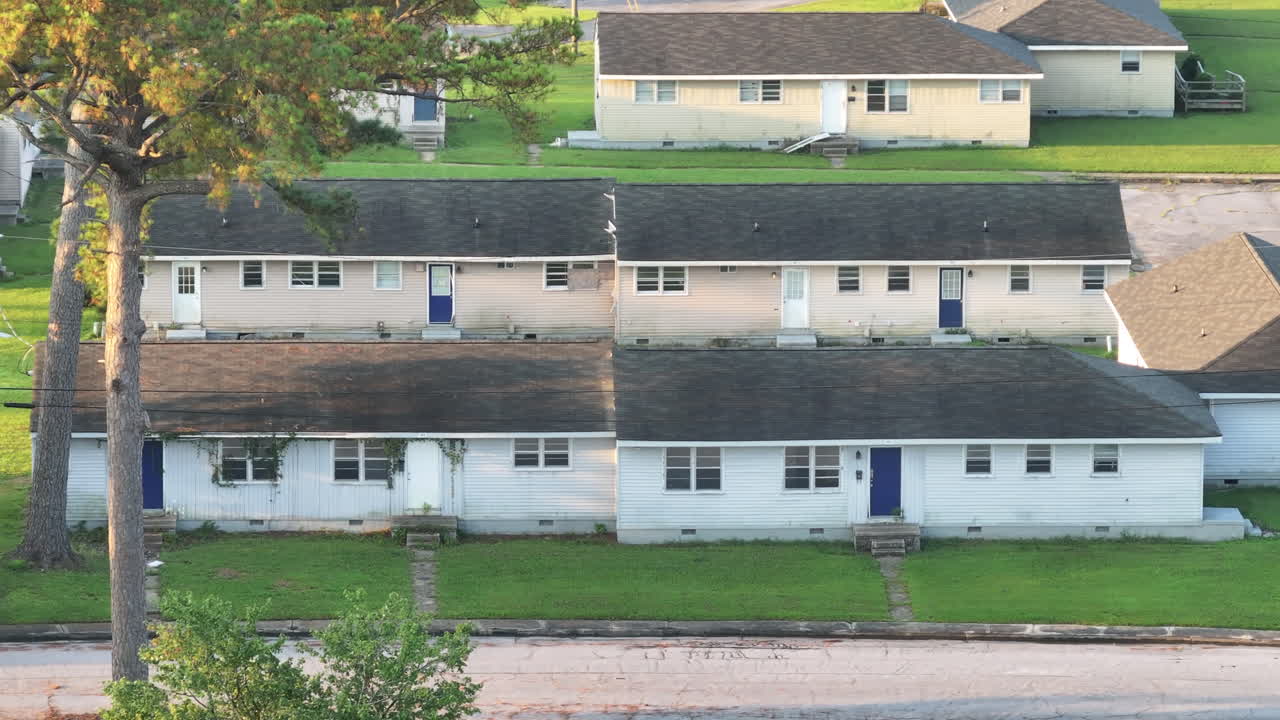 Cinematic drone shot of abandoned apartments with vegetation growing on the buildings, tight shot aerial footage