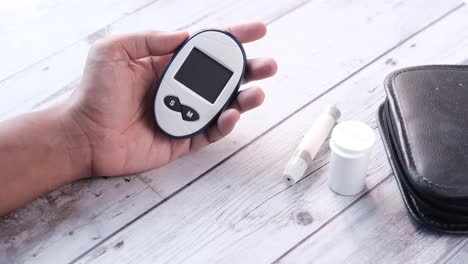 person using a blood glucose meter