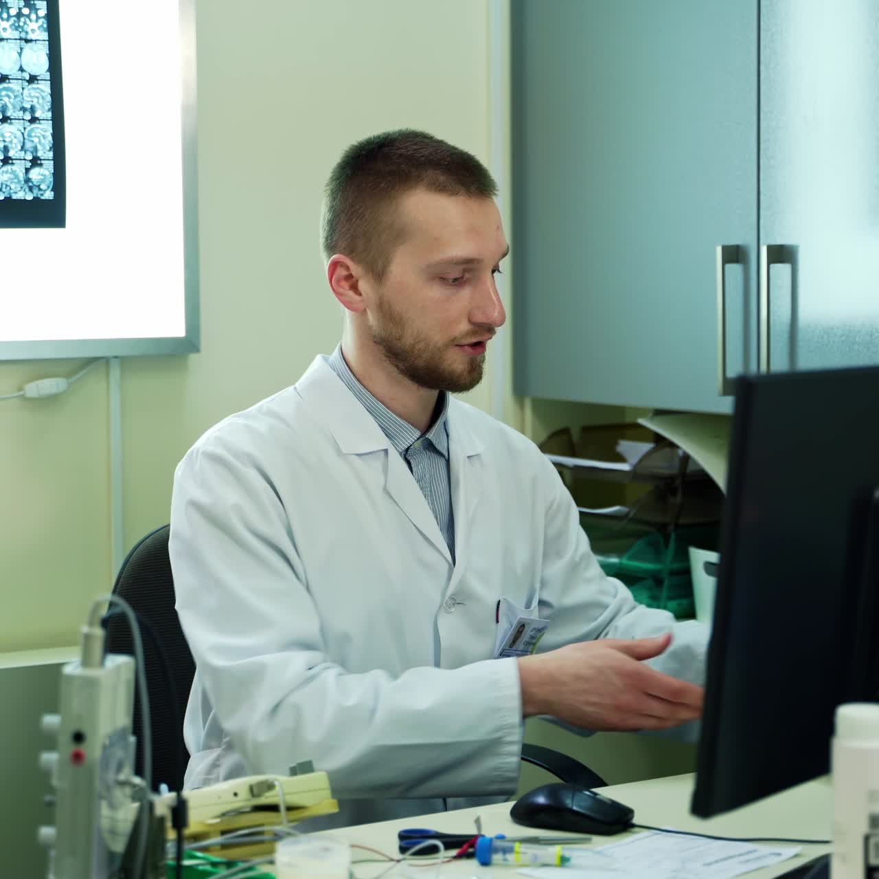 Scientists Working On Computer. Professional male doctor in a lab coat, typing on computer