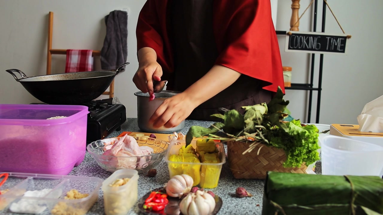 Koki mengupas bawang merah dengan pisau kecil untuk menyiapkan bahan-bahan masakan di dapur.