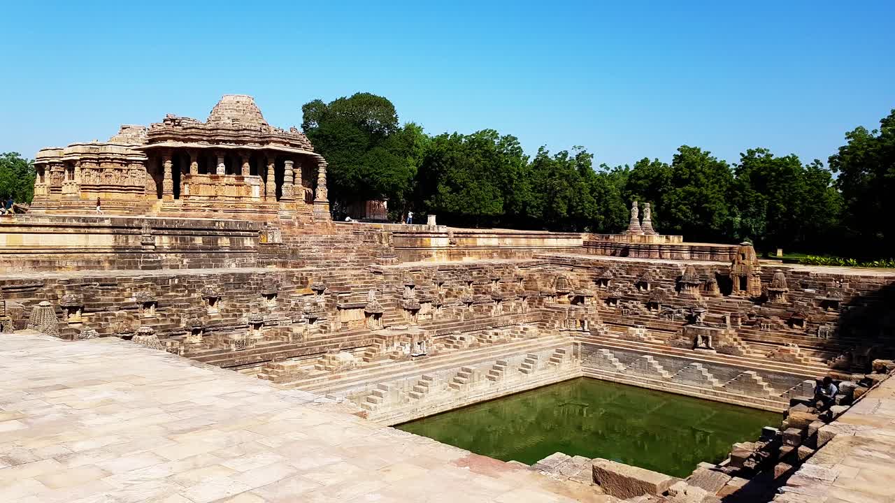 panoramic view of the sacred reservoir has steps to reach the bottom and numerous small shrines.