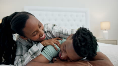 Black-couple-in-bed-with-playful-embrace