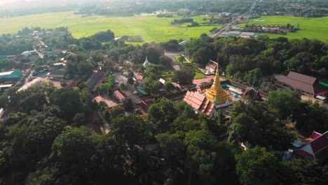 4k thai temple panoramic scene with green grass landscape on the back ground, thailand traditional culture, sunny day, natural light, asian travel destination, peaceful calm scenic, cinematic footage