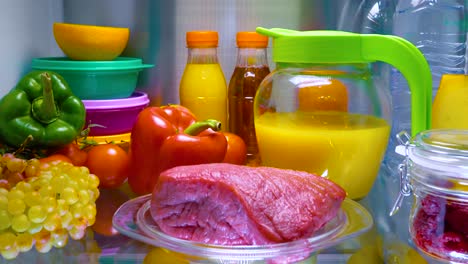 Fresh-raw-meat-on-a-shelf-open-refrigerator