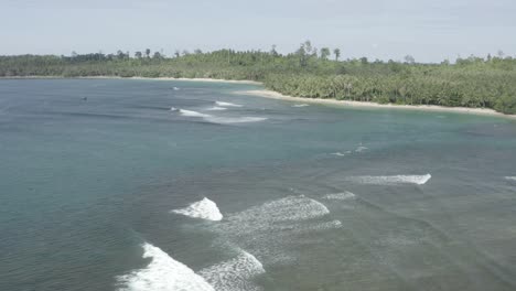 aerial flight above breaking waves in tropic indonesian bay