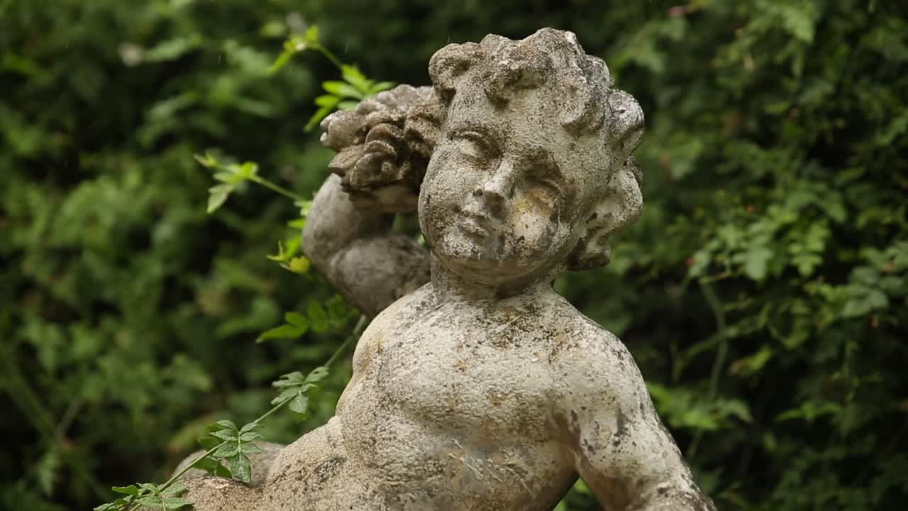 Pan up Cherub statue Green Garden