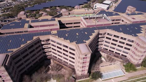 aerial view of michael e debakey va medical center, veterans hospital in houston tx usa, rooftop solar panels drone shot