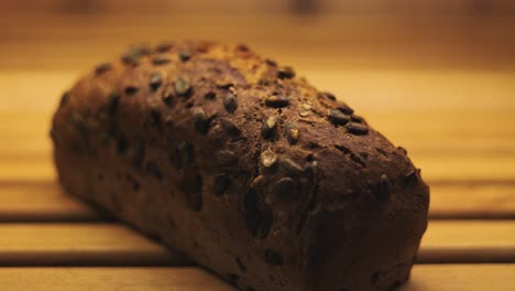 dolly in of a whole meal bread with pumpkin seeds baked well in a bread oven