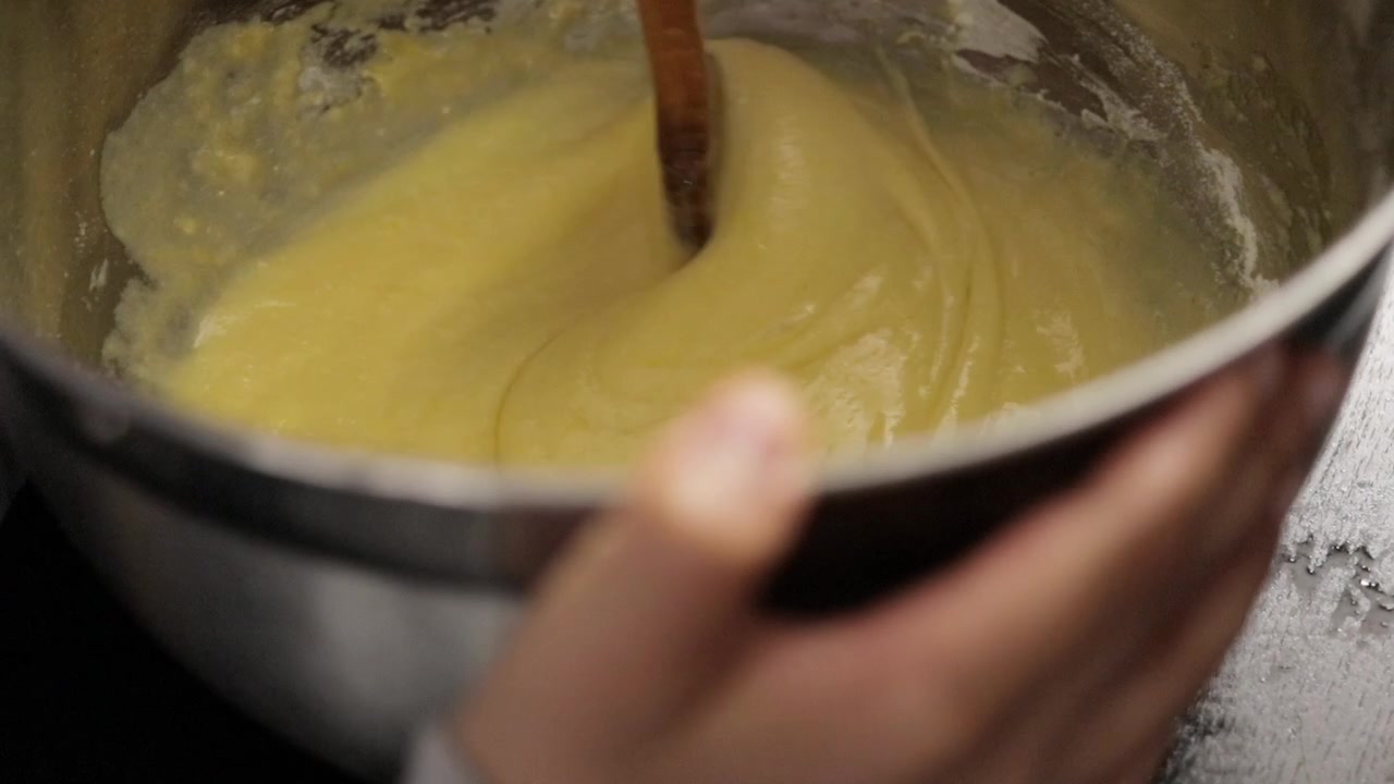 Children making a cake at home, close-up soft focus, slow motion