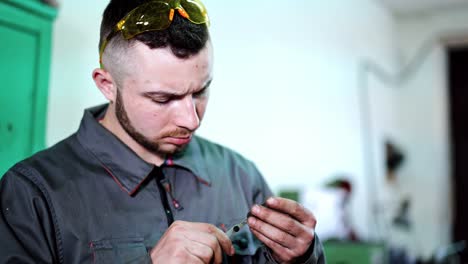 industry man using vernier caliper. man industrial engineer at factory using vernier calipers
